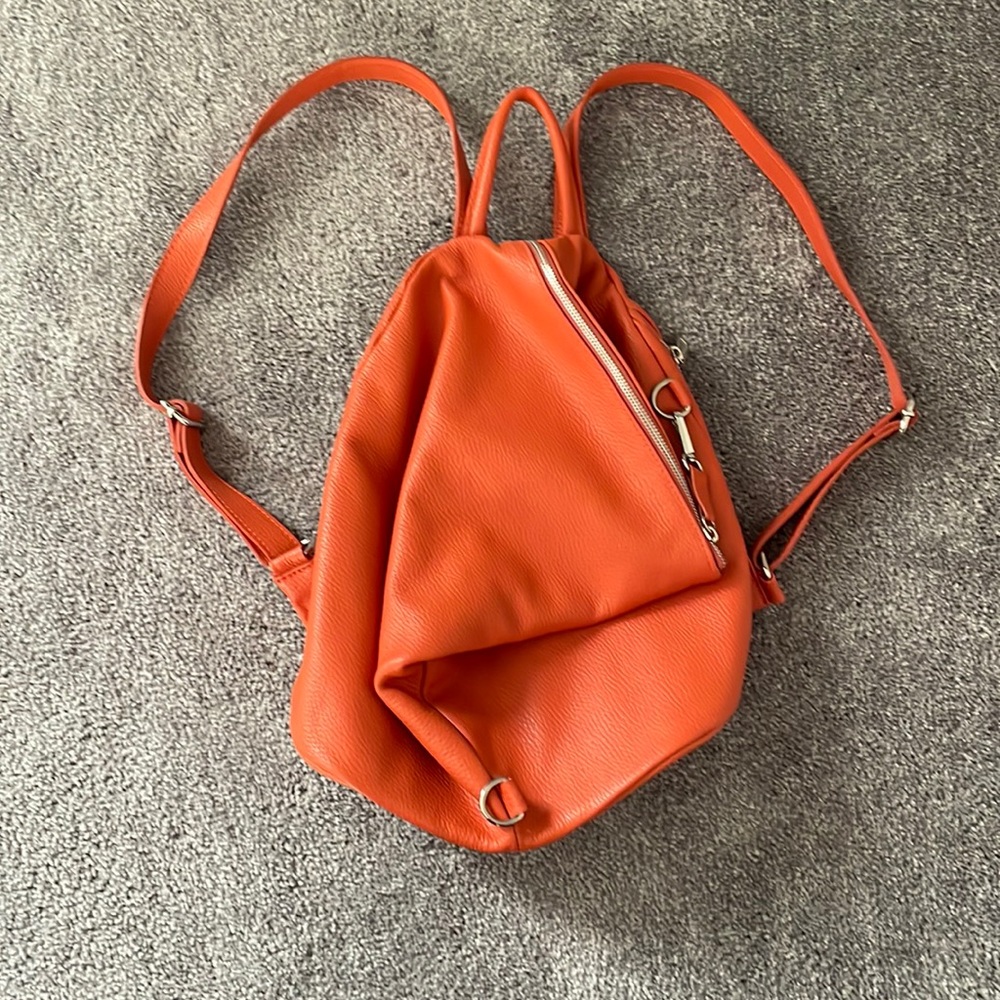 Orange leather backpack.